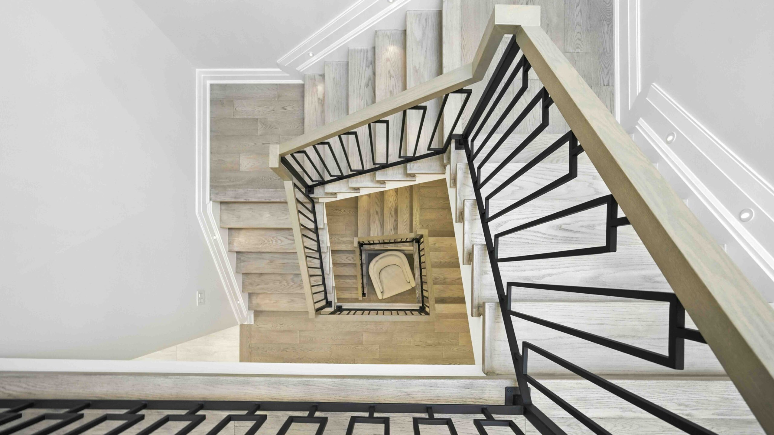 The staircase and stairwell at this luxury South Oakville home for sale is eyecatching copy